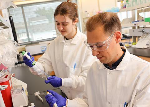 Professor and student working in a lab